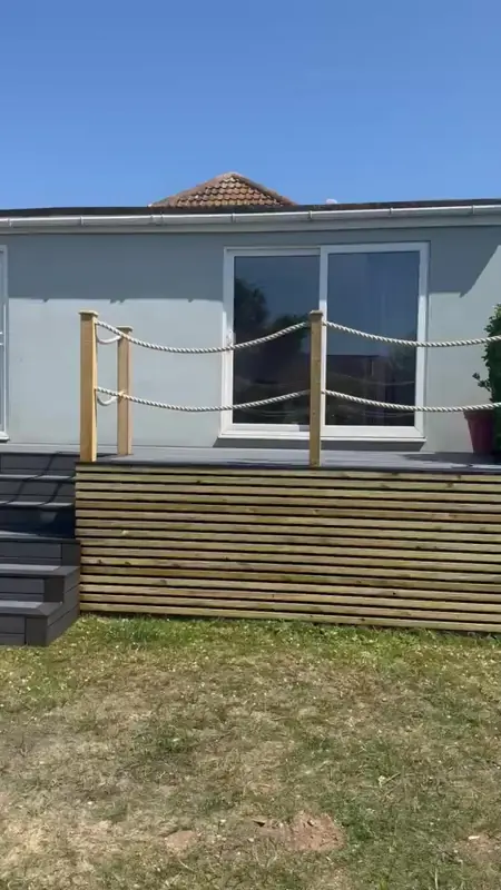 Video of a raised composite deck with steps and rope handrail
