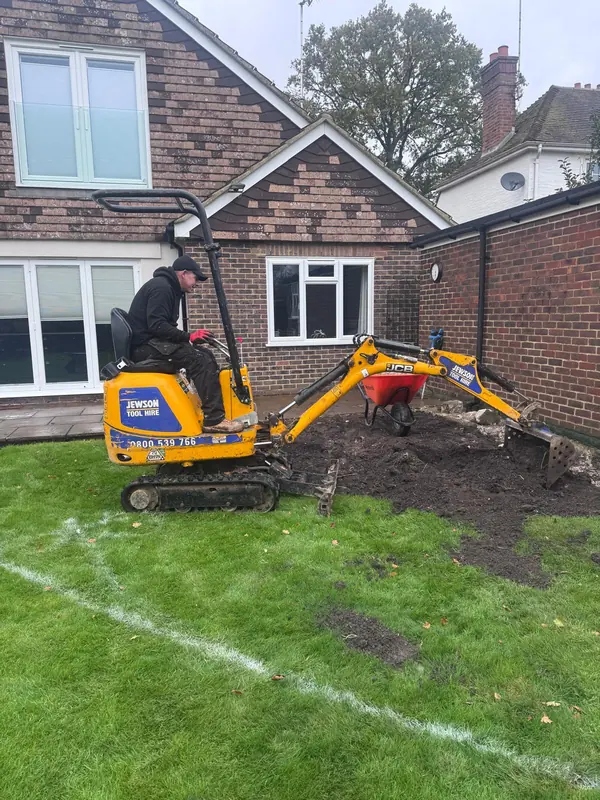 Mini digger preparing the ground for a new patio